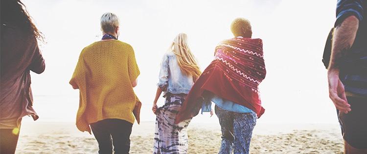 Photo of a diverse group of women walking on the beach.