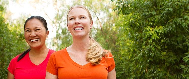 Photo of two woman smiling outside