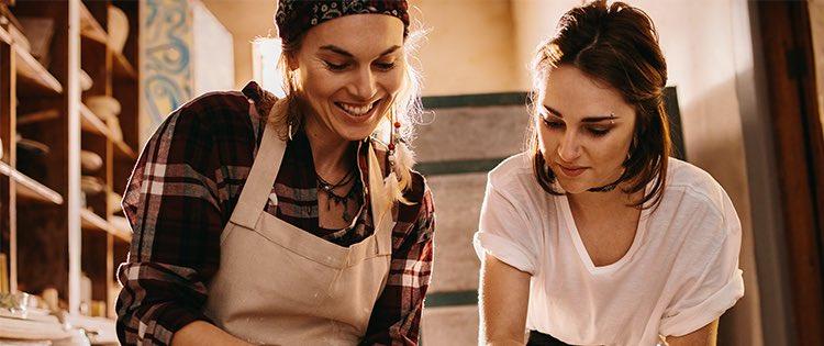 Photo of two women doing pottery together