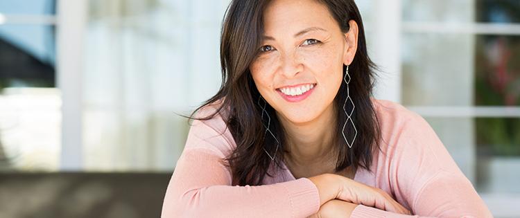 Photo of a smiling woman in a pink shirt