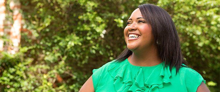 Photo of a smiling black woman outdoors