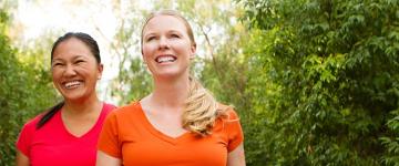 Photo of two woman smiling outside