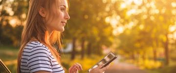 Photo of a blonde woman outside in a park