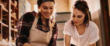 Photo of two women doing pottery together