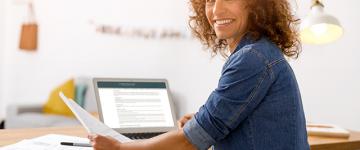 Photo of a smiling middle aged woman at a desk