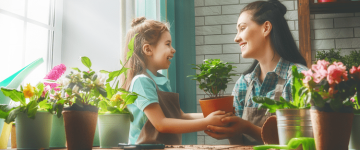 Photo of mother and daughter taking care of plants together