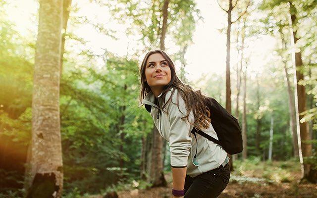 Photo of a woman hiking in the forest 