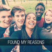 Group of five teens crowd in to take a selfie. The text "found my reasons" runs along the bottom of the image in a banner.